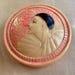 A rare 1920's French celluloid powder box with an embossed Pierrot design