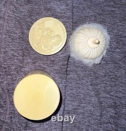An antique carved celluloid powder box