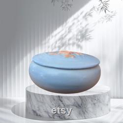 Ceramic powder container or trinket box, light blue with raised floral design on the lid. Initials on bottom. Hand decorated in 1950's