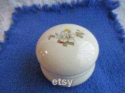 Cream colored ceramic powder box with floral motif