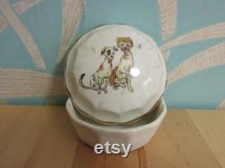 Cute vintage gilt edged porcelain powder jar with two dogs transfer detail