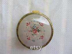 Mid century large footed powder box, petit point pink roses on hinged lid, gilt and black brass pattern. Unused. Mirror, powder puff, gauze.