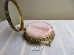 Mid century large footed powder box, petit point pink roses on hinged lid, gilt and black brass pattern. Unused. Mirror, powder puff, gauze.