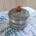 Vintage Powder Puff Holder Music Box Bakelite Knob Plays Suwannee River Aluminum Brass and Bakelite Vanity Box