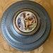 Vintage metal musical powder box, blue gray aluminum vanity trinket jewelry storage, robed couple and cherub porcelain cabochon