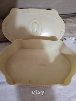 Vintage old plastic powder box with lady on lid.