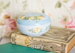 Vintage porcelain powder trinket box, lovely, soft painted yellow roses on a light blue background