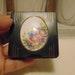 Vintage pre owned small metal powder compact with enameled flowers made by Marathon