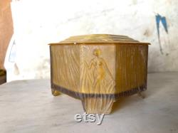 vintage amber glass and celluloid powder box with nude woman s figure on each corner